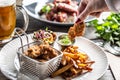 Crispy breaded chicken nuggets with french fries served on a plate with a dip and a salad Royalty Free Stock Photo