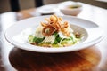 crispy calamari atop caesar salad with shaved parmesan