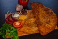 Crispy chebureks with red peppers and sauces on wooden board Royalty Free Stock Photo