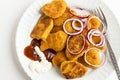 Crispy chicken nuggets in the plate with onion rings,ketchup,mayonnaise and fork. Royalty Free Stock Photo