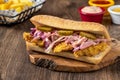 Crispy chicken sandwich baked in deep oil on a wooden background