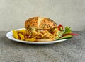 Crispy Chicken Zinger Burger with french fries and salad served in dish isolated on grey background side view of indian spices and