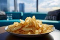 Crispy chips on a coffee table in a contemporary, unoccupied, blue hued living room