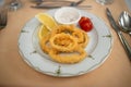 Crispy Colmar rings in batter with lemon and sauce on a Turkish style plate. Serving in a Turkish restaurant