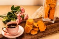 Crispy Cookies biscuits and cup of coffee and flowers isolated on wooden board top view of breakfast bakery items on table Royalty Free Stock Photo