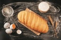 Crispy corn loaf on a dark table with ingredients