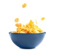 Crispy cornflakes falling into bowl Royalty Free Stock Photo