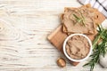 Crispy crackers with delicious meat pate and rosemary on white wooden table, flat lay. Space for text Royalty Free Stock Photo