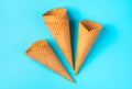 Crispy empty ice cream cones on a light blue background. Royalty Free Stock Photo