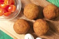Crispy Falafel Balls with tomatoes on the wood board