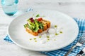 Crispy fish roulade with greens and white sauce drops Royalty Free Stock Photo