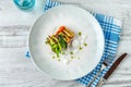 Crispy fish roulade with greens and white sauce drops Royalty Free Stock Photo