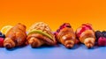 Crispy fresh croissant on a neon background decorated with berries and fruits. Golden crust for breakfast.