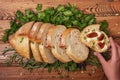 Neatly sliced Ã¢â¬â¹Ã¢â¬â¹bread with fresh herbs and a sandwich with butter and sun-dried tomatoes