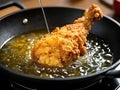 Crispy fried chicken being pulled out of hot oil Royalty Free Stock Photo