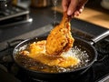 Crispy fried chicken being pulled out of hot oil Royalty Free Stock Photo