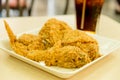 Crispy fried chicken with glass of cola closeup