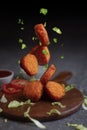 Crispy fried chicken nuggets with Ketchup on wooden board.flying chicken nuggets