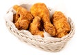 Crispy fried chicken pieces in a white woven basket isolated on white Royalty Free Stock Photo