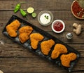 Raw crispy chicken wings with sauce, top view. Royalty Free Stock Photo