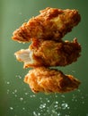 Crispy Fried Chicken Wings Floating Mid Air with Flying Juicy Droplets on Green Background Royalty Free Stock Photo