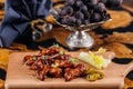 Crispy Fried Chicken Wings with sauce served on wooden board isolated on table side view of arabic appetizer food Royalty Free Stock Photo