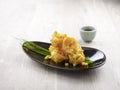 Crispy fried Crystal Prawns tossed with Salted Egg Yolk with chopsticks served in a dish isolated on mat side view on grey Royalty Free Stock Photo