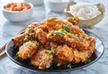 Crispy fried korean chicken wings in galbi sauce with pickled radish, kimchi, and rice side dishes