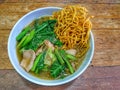 Crispy fried noodle with pork soaked on wooden background Royalty Free Stock Photo