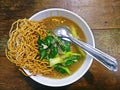 Crispy fried noodle with pork soaked on wooden background in vintage colur mode Royalty Free Stock Photo