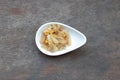 Crispy fried pock and garlic in white ceramic cup on wooden table. Thai food