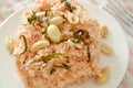 Crispy fried thin rice noodles with coconut cream topping peanut and slice lemon leaf on plate Royalty Free Stock Photo
