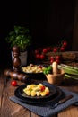 A crispy gnocchi with roasted asparagus and tomatoes