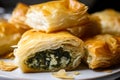Crispy and golden bourekas stuffed with creamy spinach and feta cheese, with flaky layers of phyllo pastry visible in a close-up