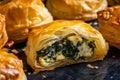 Crispy and golden bourekas stuffed with creamy spinach and feta cheese, with flaky layers of phyllo pastry visible in a close-up