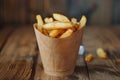 Crispy golden french fries in paper cone