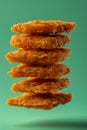 Crispy Golden Fried Chicken Tenders Stacked Vertically Against a Teal Background Fast Food Concept