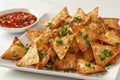 Crispy Golden Fried Wontons with Fresh Parsley and Sweet Chili Sauce on White Plate