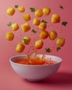 Crispy Golden Potato Balls Splashing into Tomato Soup on Pink Background