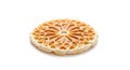 Crispy golden round waffle with intricate geometric pattern isolated on white background Royalty Free Stock Photo