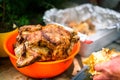 Crispy grilled rotisserie chicken in orange bowl at piknik party Royalty Free Stock Photo