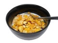 Crispy and healthy organic breakfast cereal flakes with red dried cranberry and cold soy milk in dark black handmade pottery bowl