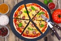 Crispy hot pizza on old wooden table Royalty Free Stock Photo