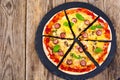 Crispy hot pizza on old wooden table Royalty Free Stock Photo