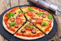 Crispy hot pizza on old wooden table Royalty Free Stock Photo