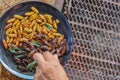 Crispy insects are served in black ceramic plates placed on tables made of steel grates, and fried insects are a popular food Royalty Free Stock Photo