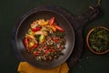 Crispy lentil, kale chips, roasted pepper, tomatoes,roasted chicken breast, parmesan salad. Green dark wooden background. Top view Royalty Free Stock Photo