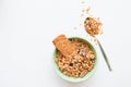 Crispy muesli in boal and on spoon dry Breakfast isolated on white background selective focus, top view