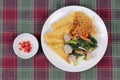 Crispy noodle topped kale soup with meatball and spicy sauce. Royalty Free Stock Photo