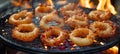 Crispy onion rings fried to perfection in golden oil, achieving ultimate crunchiness Royalty Free Stock Photo